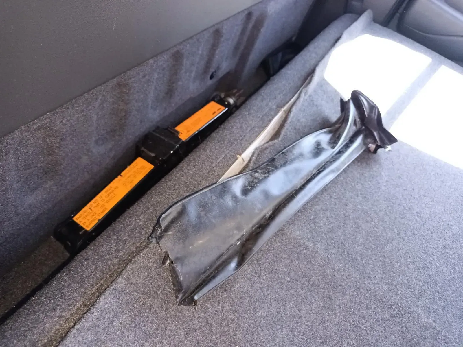 Car Jack and Tool Bag in the Back of a Vehicle, Resting on Gray Carpet and Foam — South West 4WD Wreckers In Brisbane, QLD
