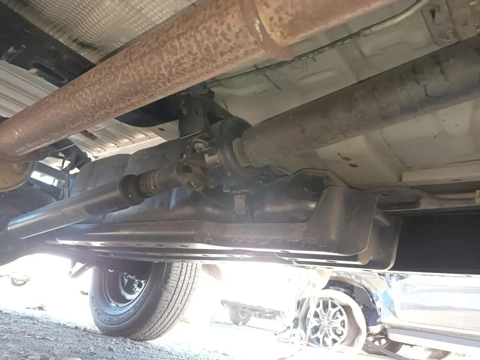Undercarriage of a Vehicle With Drive Shaft, Exhaust Pipe, and Tyre Visible — South West 4WD Wreckers In Brisbane, QLD