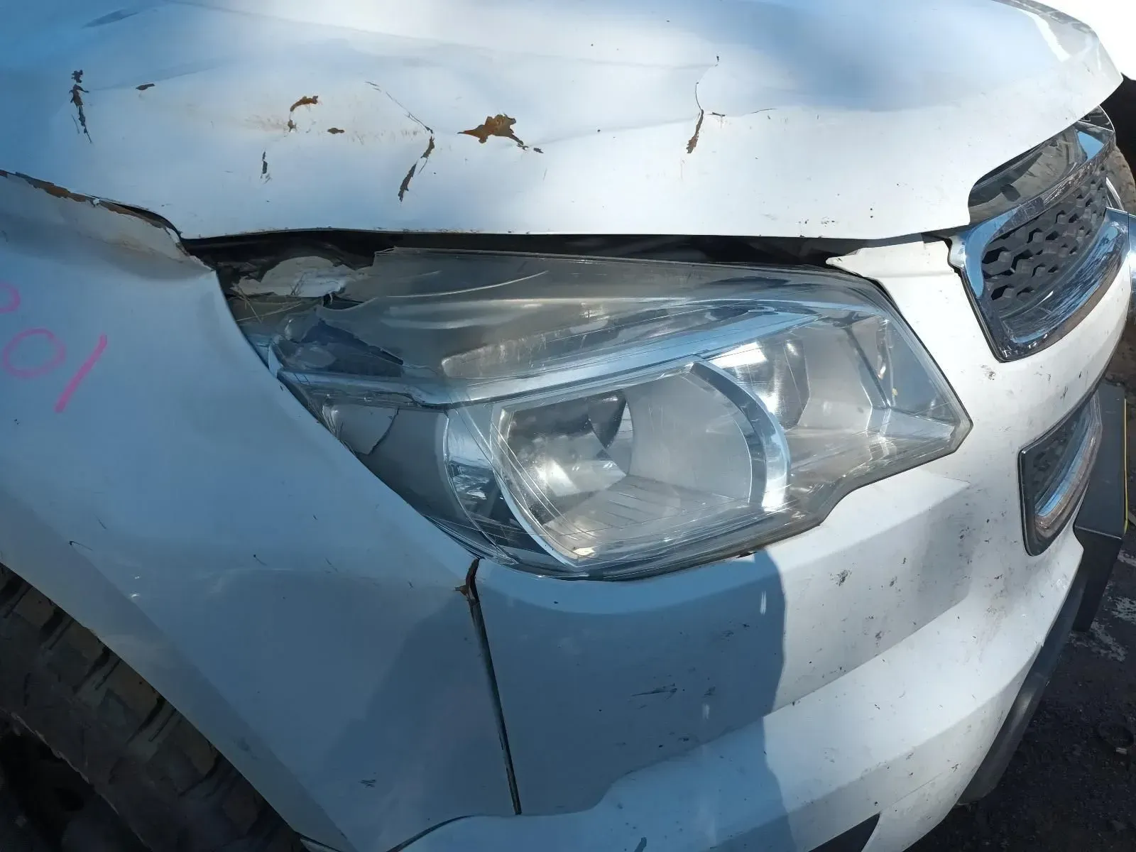 Damaged White Car Front, Headlight Visible, Crumpled Hood — South West 4WD Wreckers In Brisbane, QLD