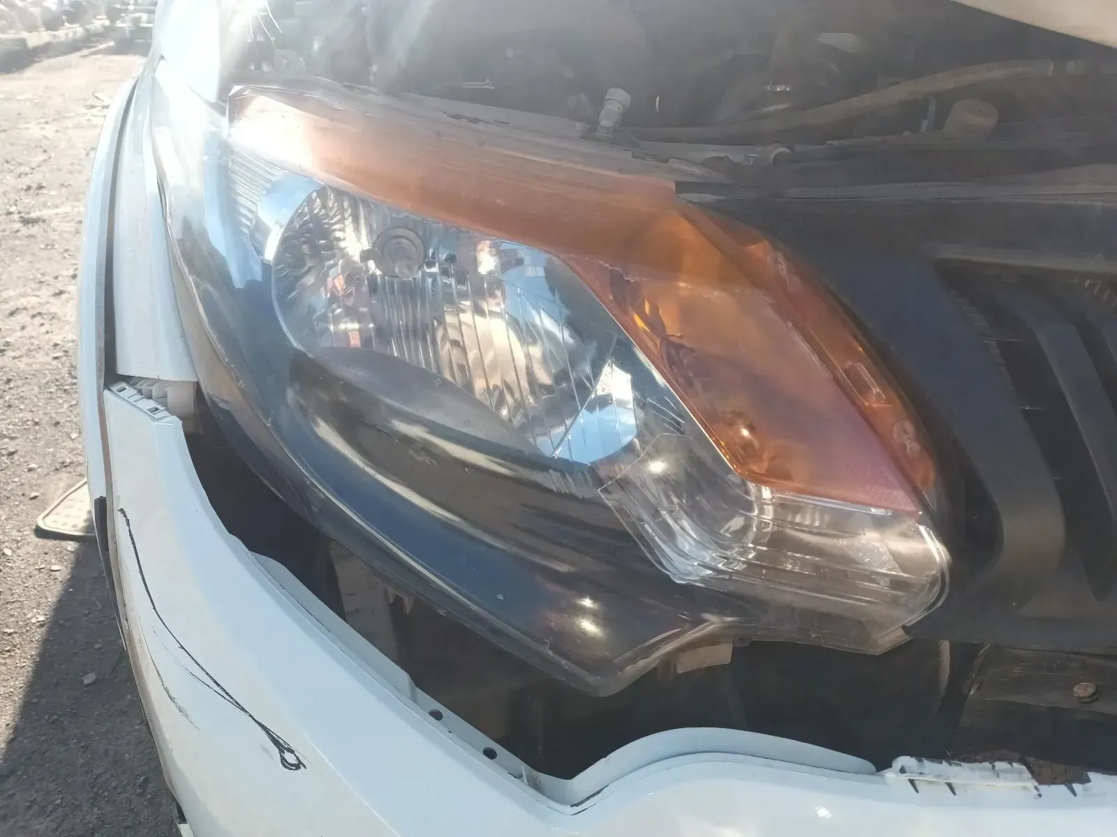 White Car Headlight With Orange Turn Signal and Black Trim — South West 4WD Wreckers In Brisbane, QLD