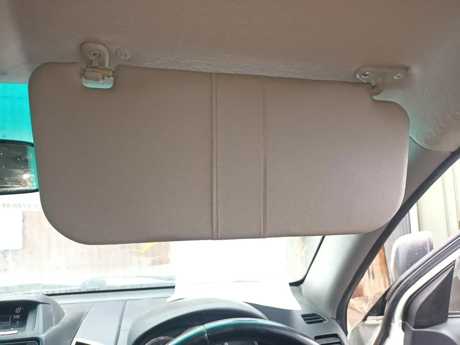 Beige Car Sun Visor Attached to the Roof Above the Dashboard, Blocking Sunlight — South West 4WD Wreckers In Brisbane, QLD