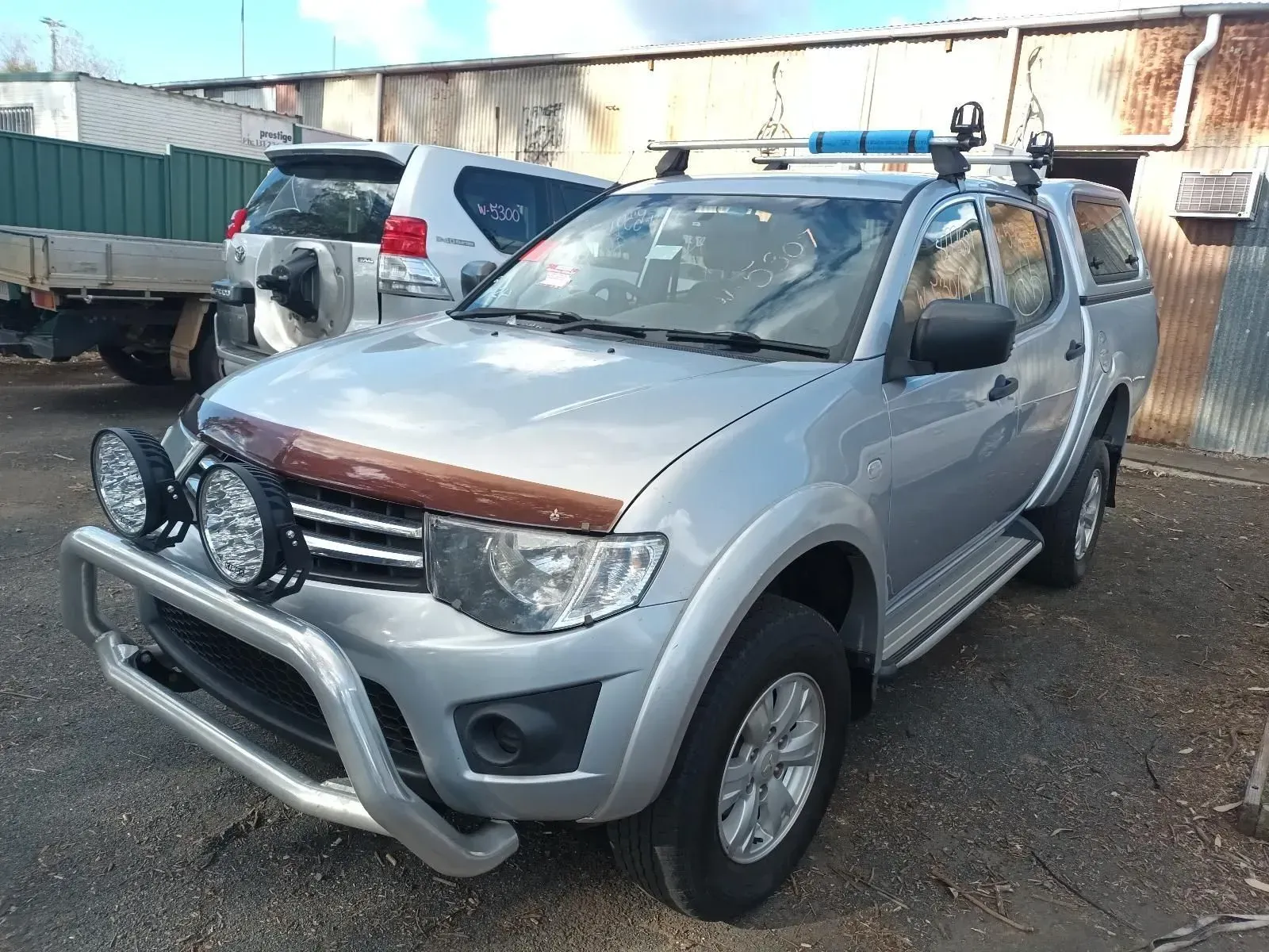 Silver Pickup Truck With Bull Bar, Spotlights, and Roof Rack Parked Outside — South West 4WD Wreckers In Brisbane, QLD