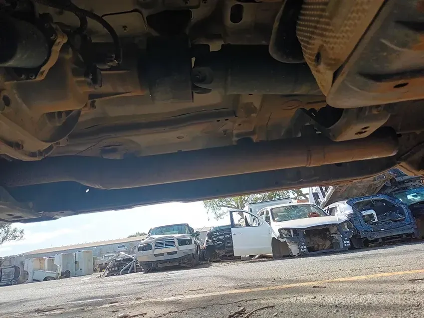 The Underside of a Car is Shown in a Parking Lot — South West 4WD Wreckers In Brisbane, QLD