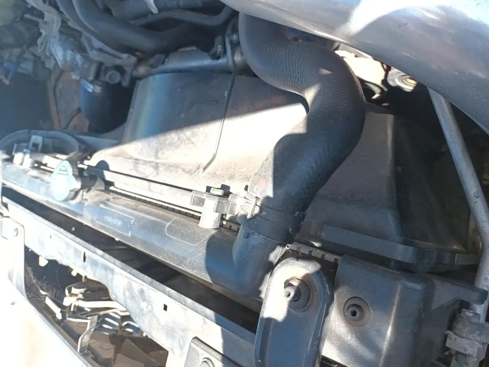Black Radiator With a Bent, Thick Hose, Viewed From Above in Engine Bay — South West 4WD Wreckers In Brisbane, QLD