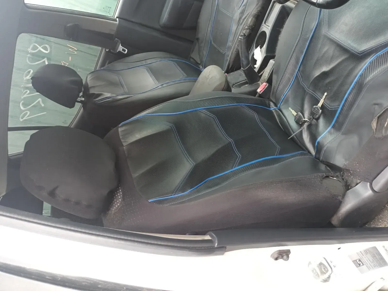 Black Car Seats With Blue Stitching, Partially Visible in a Vehicle Interior — South West 4WD Wreckers In Brisbane, QLD