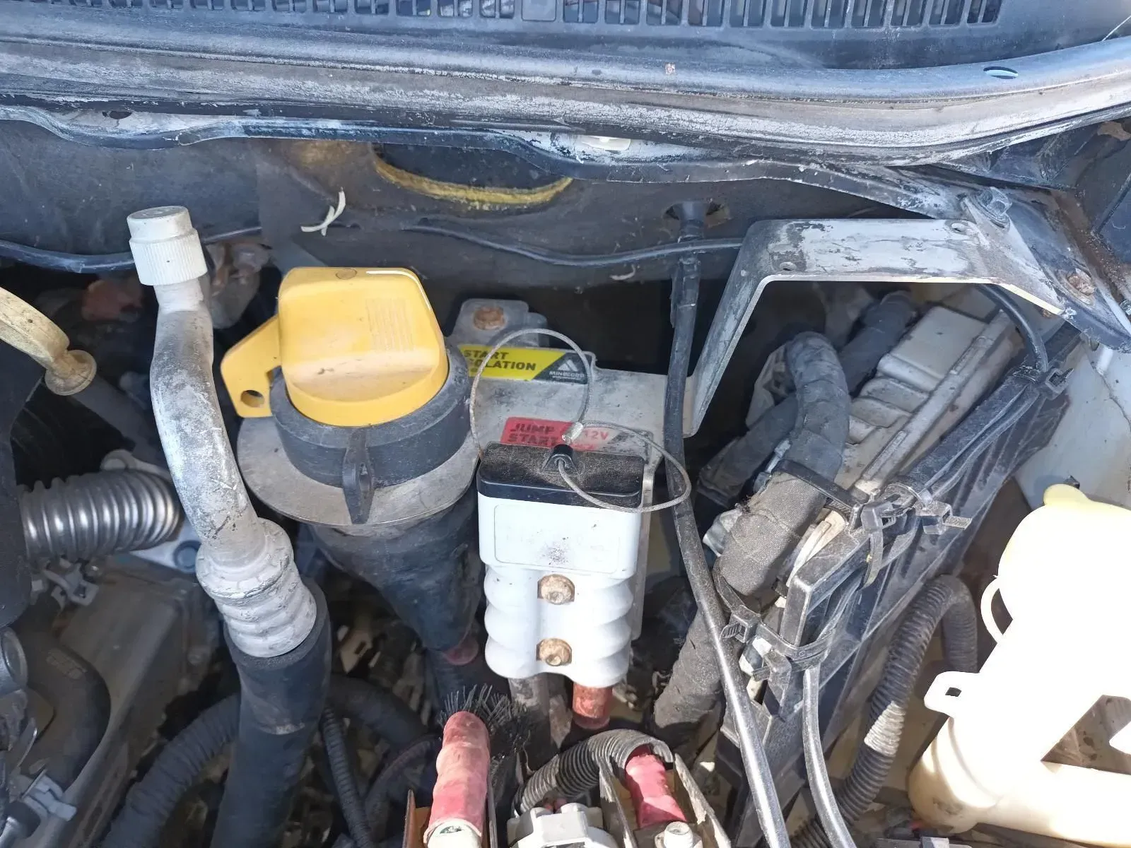 An Open Car Engine Bay With a Battery and Various Components — South West 4WD Wreckers In Brisbane, QLD
