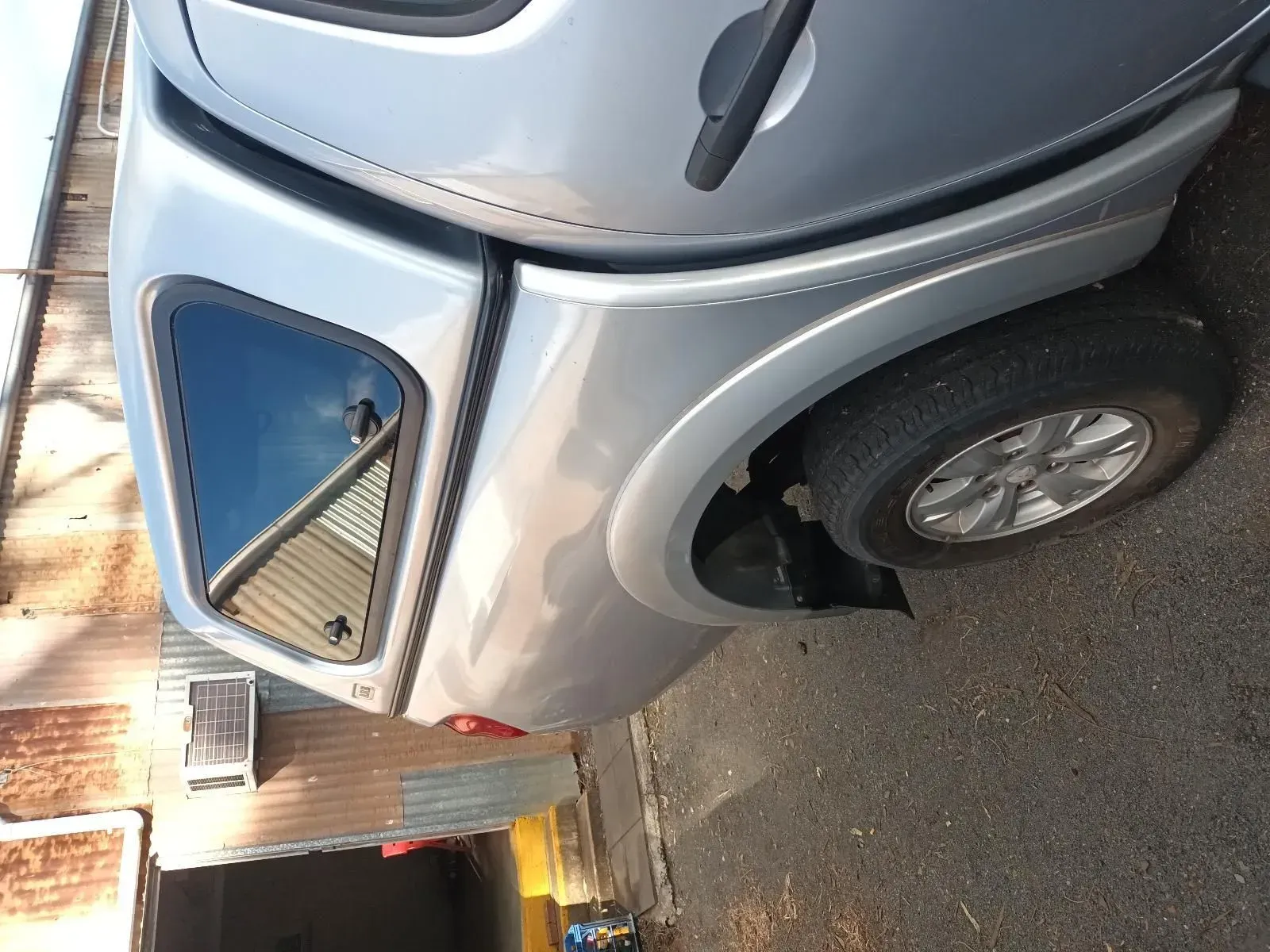 Silver Pickup Truck With a Camper Shell Parked on Asphalt — South West 4WD Wreckers In Brisbane, QLD