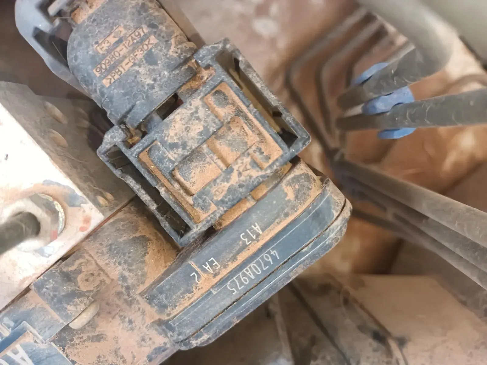 Close-up of a Dusty, Black Car Part With a Connector, Text, and Part Number — South West 4WD Wreckers In Brisbane, QLD