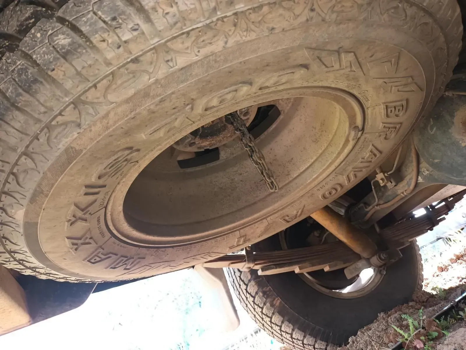 Spare Tyre Mounted Under a Vehicle, With a Chain, Dirty, Outdoors — South West 4WD Wreckers In Brisbane, QLD