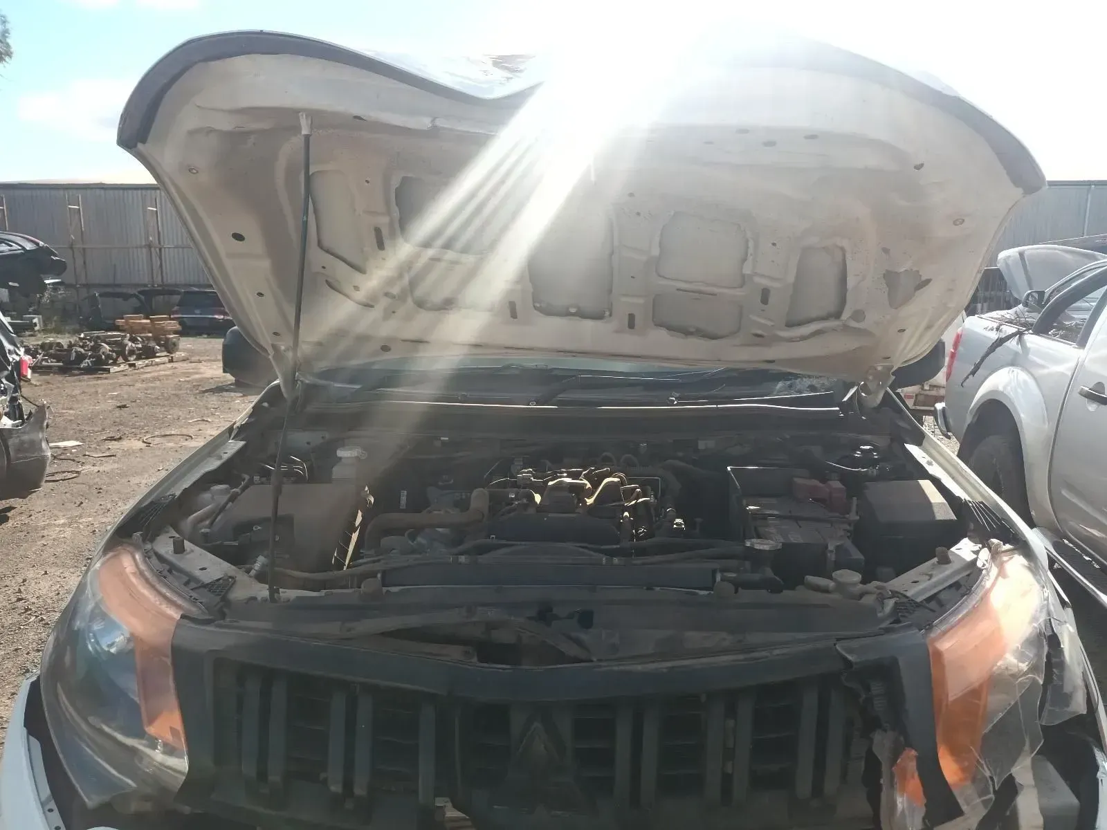 White Truck With Open Hood; Sun Shining Down. Junk Yard Setting — South West 4WD Wreckers In Brisbane, QLD