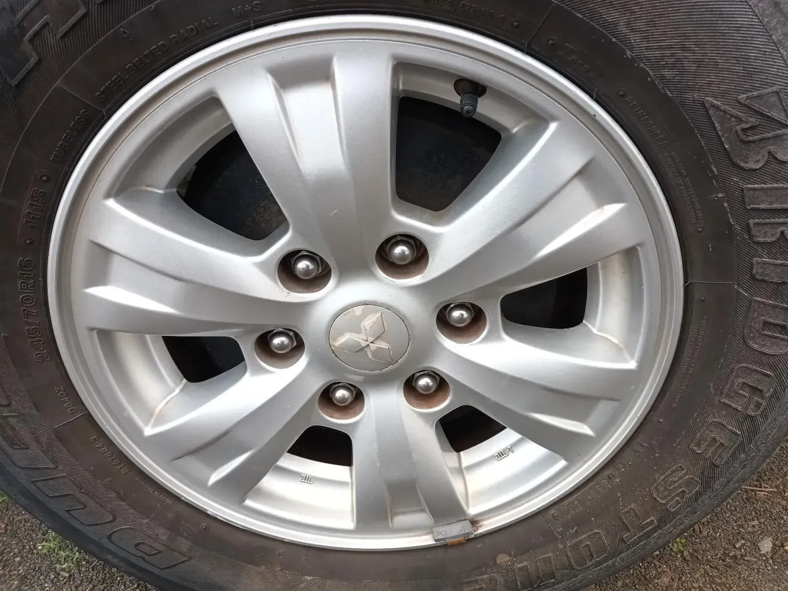 Silver Alloy Wheel With a Mitsubishi Logo on a Black Tyre — South West 4WD Wreckers In Brisbane, QLD