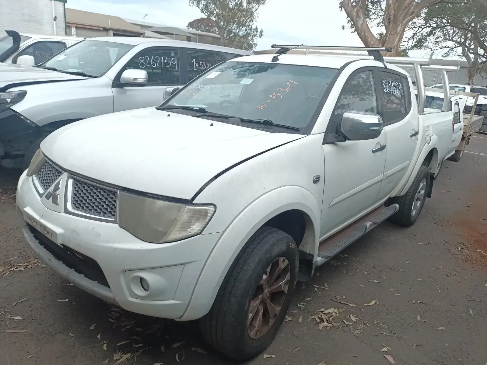 White Mitsubishi Triton Pickup Truck, Damaged, in a Junkyard — South West 4WD Wreckers In Brisbane, QLD