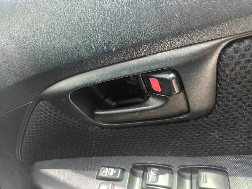 A Close Up of a Car Door Handle With a Red Button on It — South West 4WD Wreckers In Brisbane, QLD