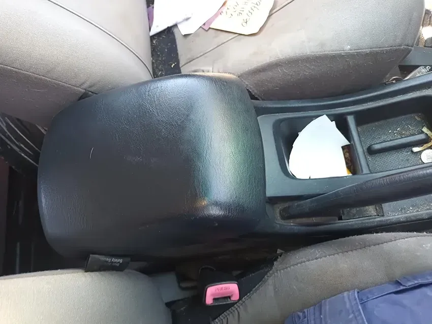 A Black Arm Rest in a Car With a Pink Button on It — South West 4WD Wreckers In Brisbane, QLD