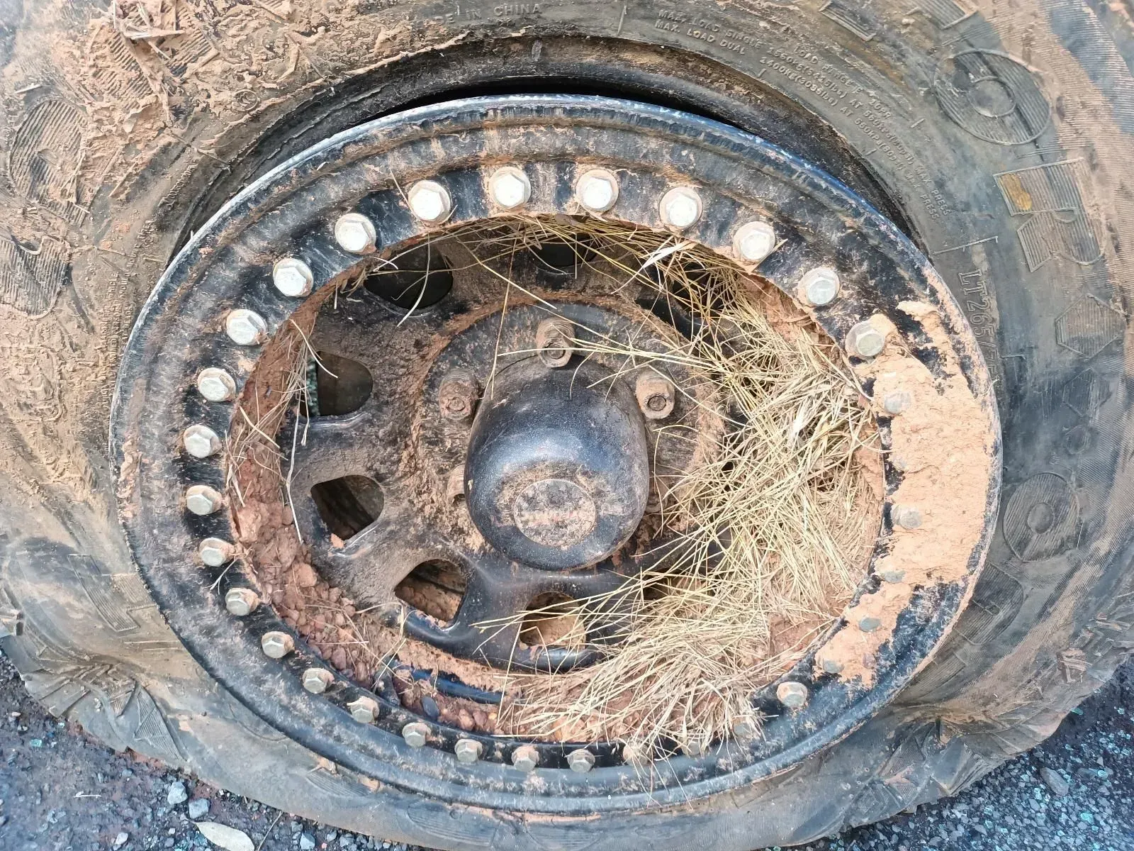 Close-up of a Dirty, Rusty Wheel With Grass and Mud in the Center — South West 4WD Wreckers In Brisbane, QLD