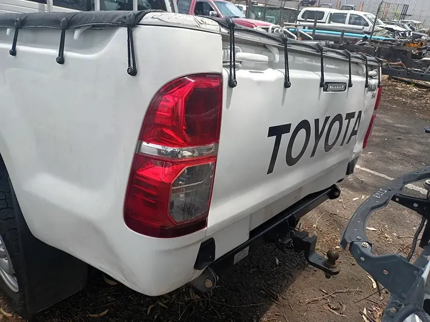 A White Toyota Truck is Parked in a Parking Lot — South West 4WD Wreckers In Brisbane, QLD