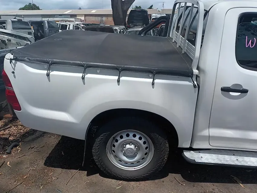 A White Truck With a Black Bed Cover is Parked in a Parking Lot — South West 4WD Wreckers In Brisbane, QLD