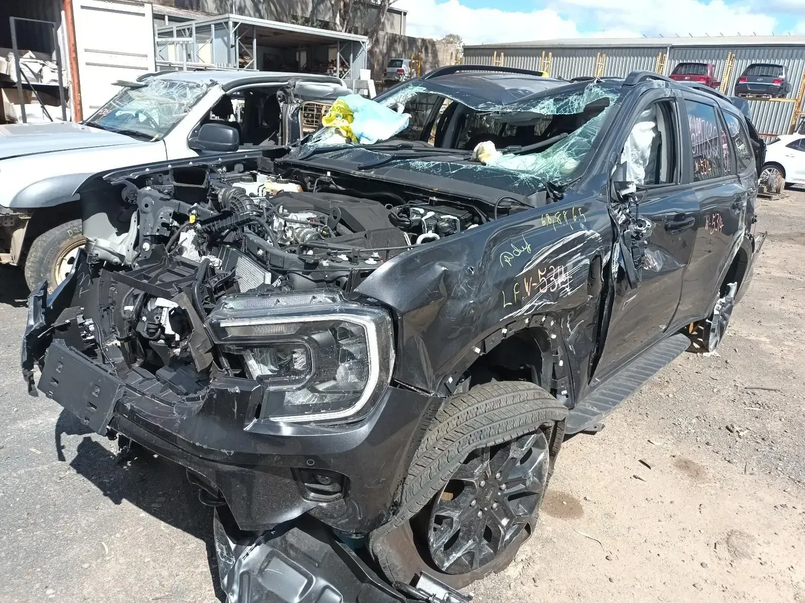 Heavily Damaged Black Suv in a Salvage Yard — South West 4WD Wreckers In Brisbane, QLD