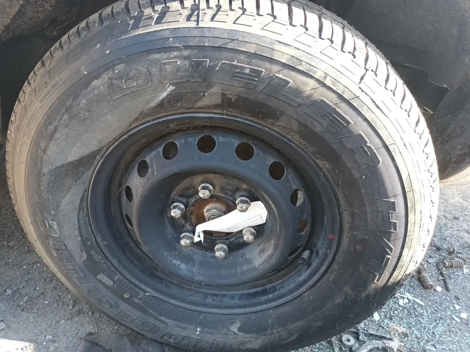 Black Tyre and Steel Rim on a Vehicle. the Tyre Shows Wear — South West 4WD Wreckers In Brisbane, QLD