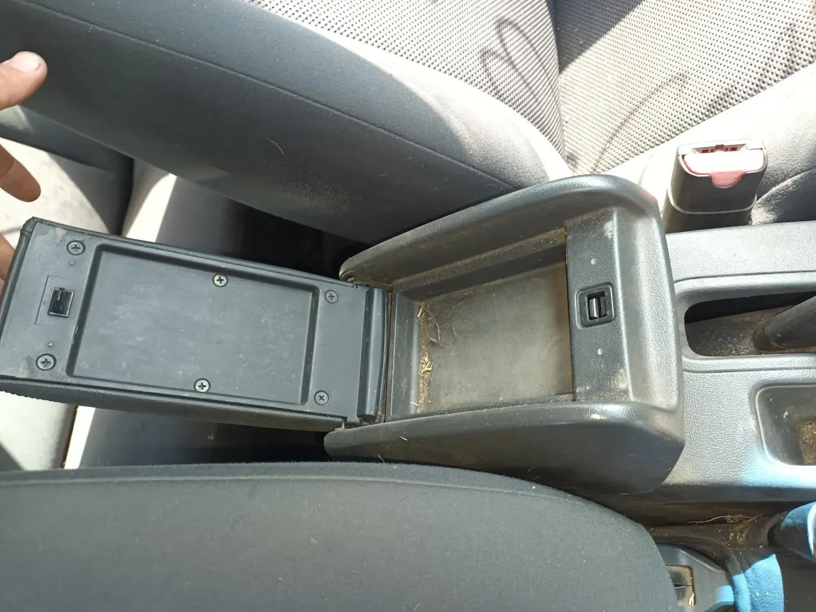 Open Car Console Compartment, Black Interior With Dust, Seatbelt Buckle Visible — South West 4WD Wreckers In Brisbane, QLD
