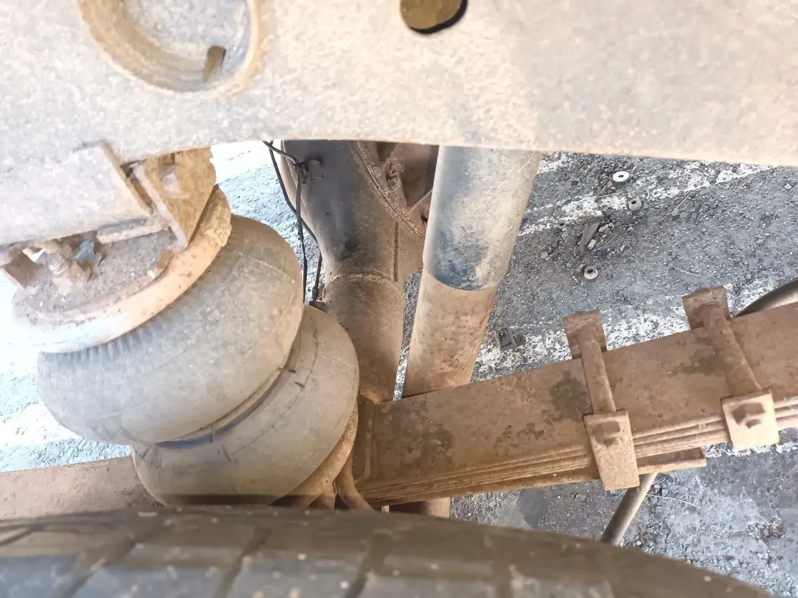 Underside of a Vehicle With Air Springs and Leaf Springs Visible Near a Tyre — South West 4WD Wreckers In Brisbane, QLD