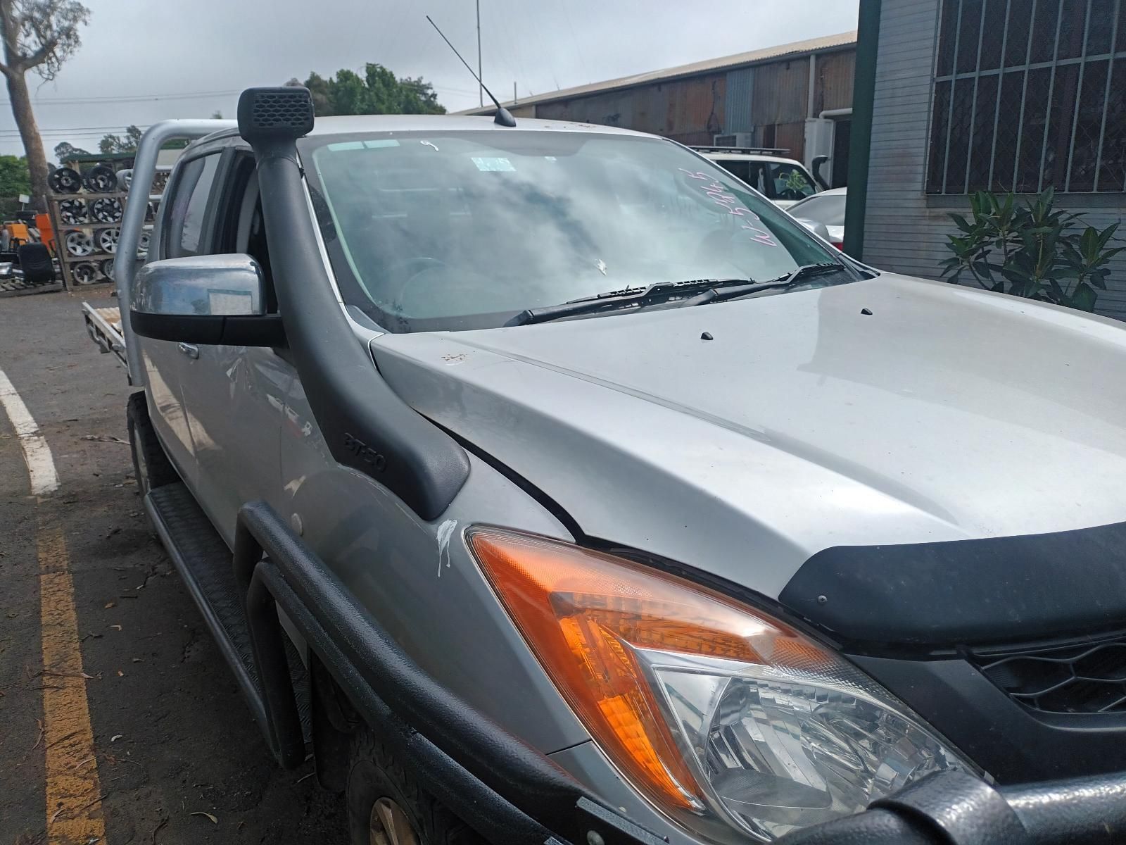 A Silver Truck with a Snorkel on the Hood is Parked in a Parking Lot — South West 4WD Wreckers in Harristown, QLD