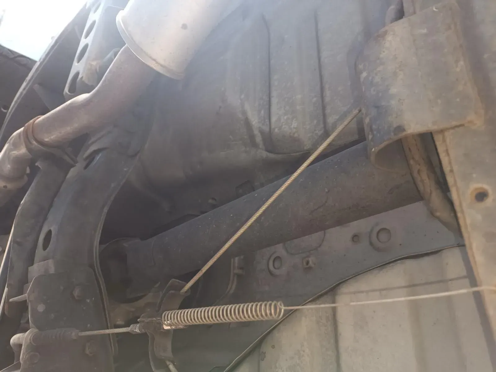 Undercarriage View Showing Metal Frame, Exhaust, and Cable With Spring — South West 4WD Wreckers In Brisbane, QLD