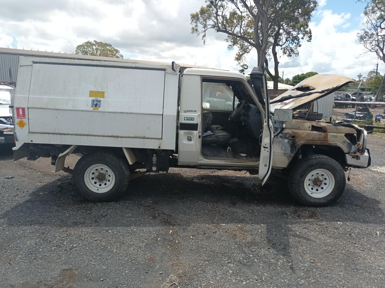 A White Truck with the Hood Open is Parked in a Parking Lot — South West 4WD Wreckers in Harristown, QLD 