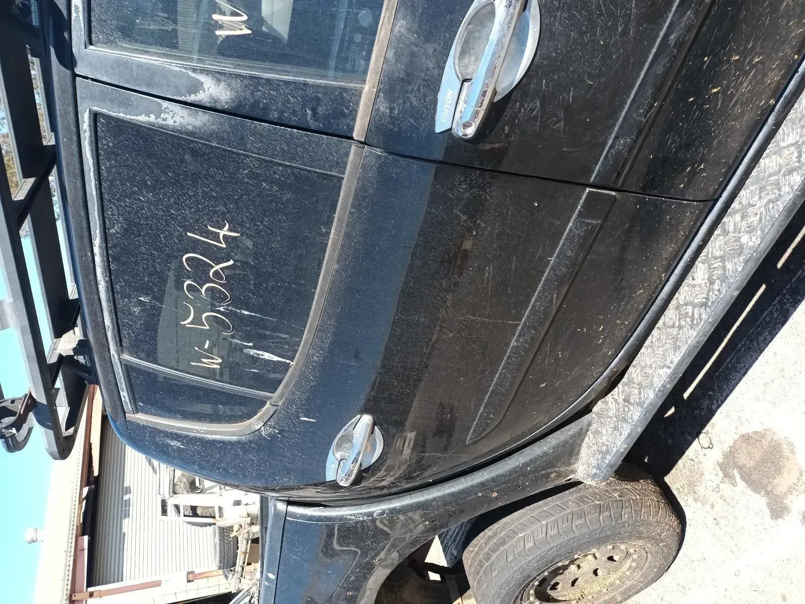 Black Vehicle Side With Dirty Windows, Door Handles, and Tyre — South West 4WD Wreckers In Brisbane, QLD