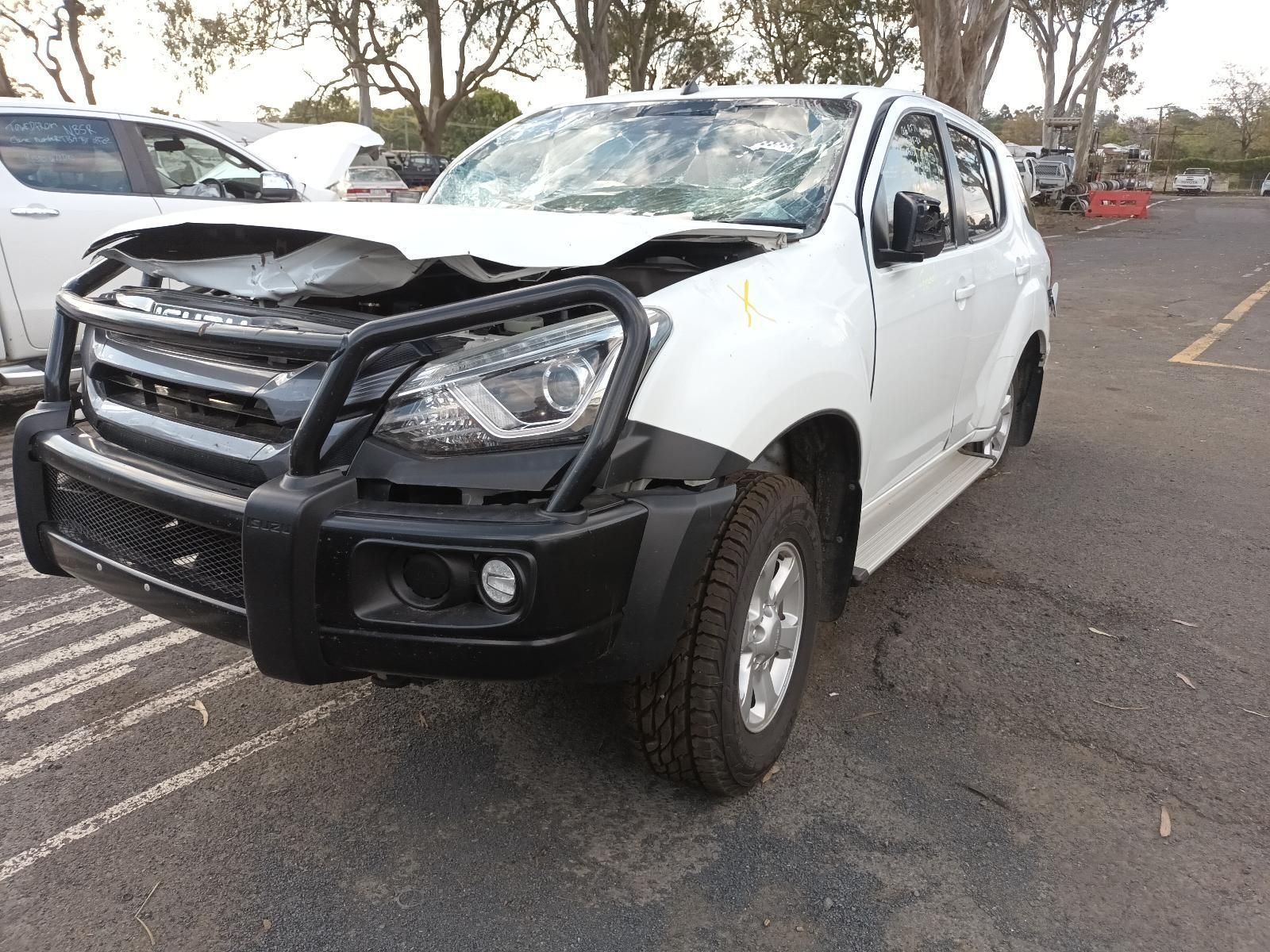 A White SUV with a Black Bumper is Parked in a Parking Lot — South West 4WD Wreckers in Harristown, QLD 