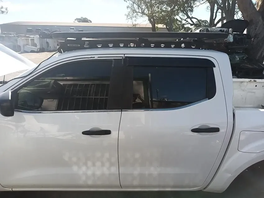 A White Truck with a Roof Rack is Parked in a Parking Lot — South West 4WD Wreckers In Brisbane, QLD
