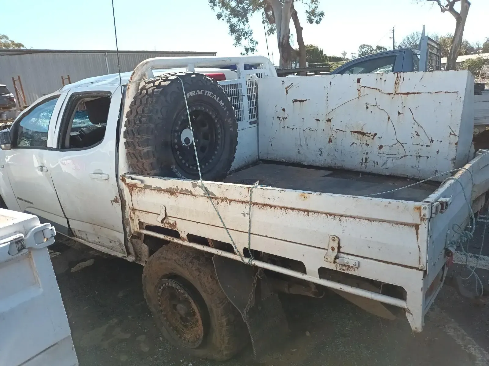 White Pickup Truck With Flatbed and Spare Tyre — South West 4WD Wreckers In Brisbane, QLD