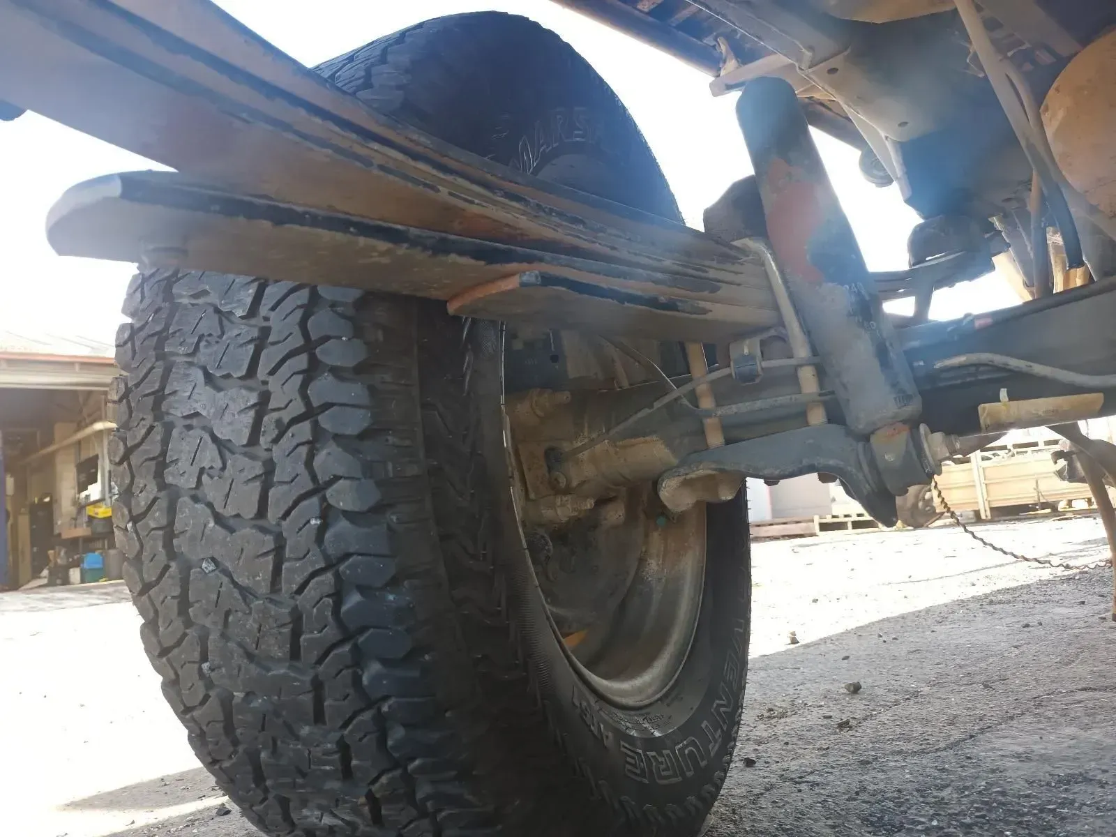 Close-up View of a Vehicle's Rear Tyre, Leaf Springs, and Shock Absorber — South West 4WD Wreckers In Brisbane, QLD