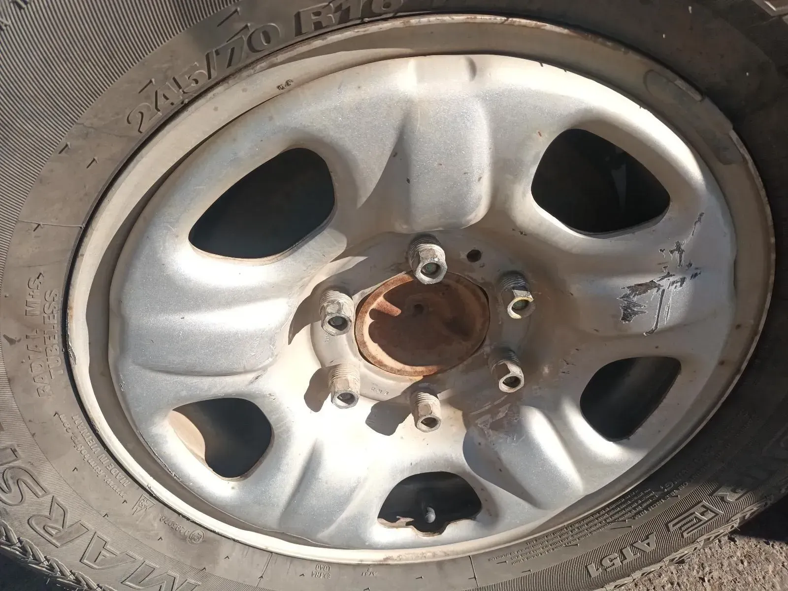 Close-up of a Vehicle's Wheel With a White Rim, Showing Tyre Details and Lug Nuts — South West 4WD Wreckers In Brisbane, QLD