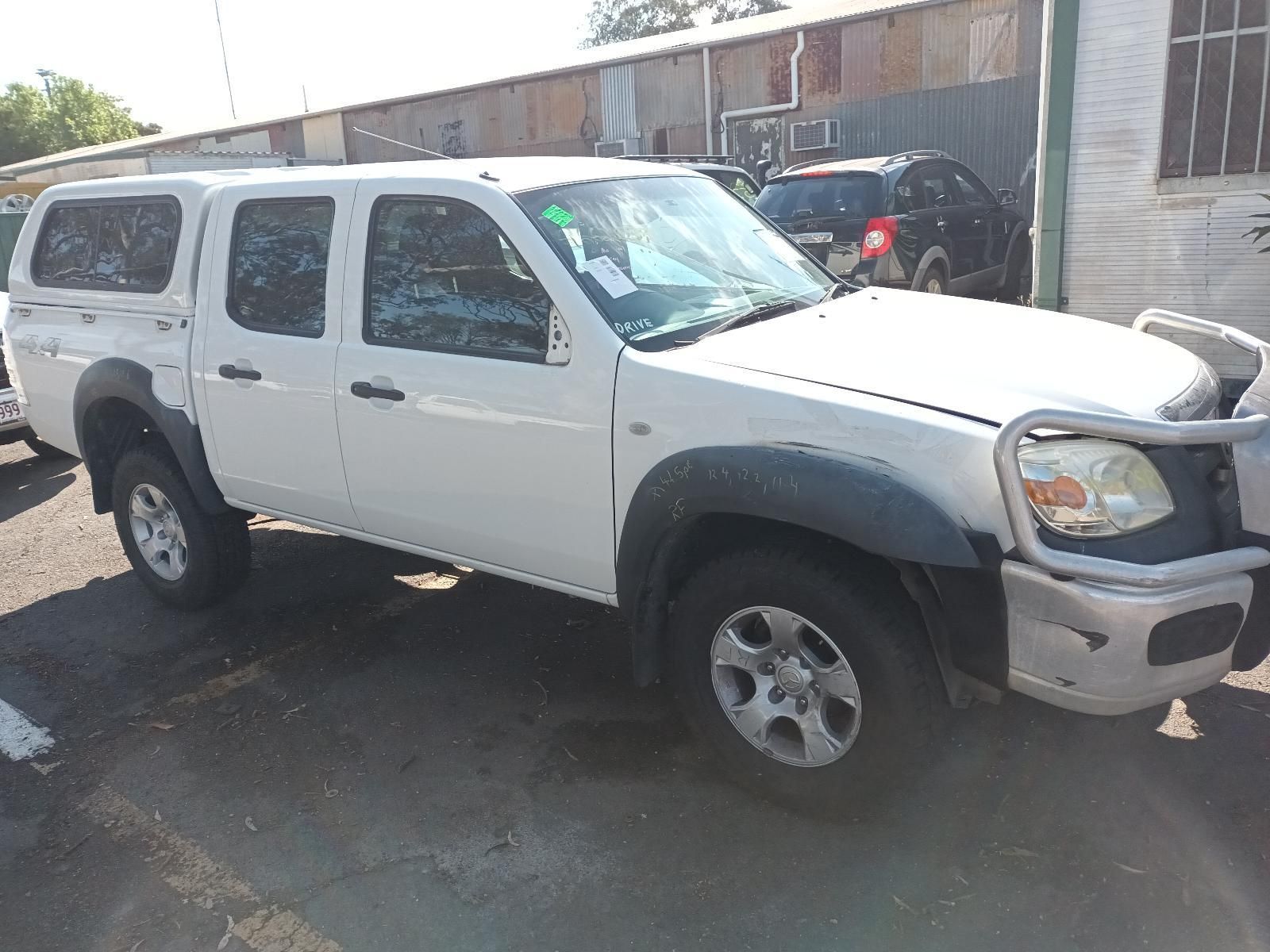 A White Truck with a Canopy is Parked — South West 4WD Wreckers In Brisbane, QLD