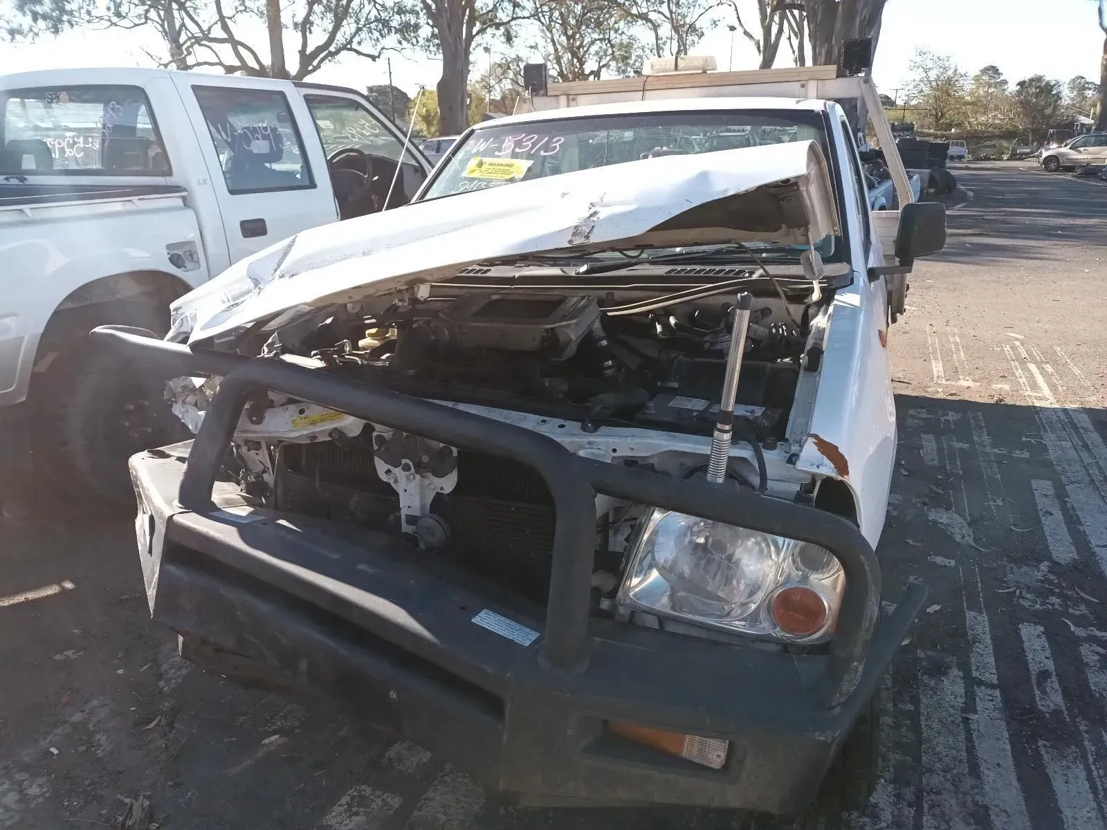 Damaged White Pickup Truck in Junkyard, Front End Crushed, Black Bull Bar — South West 4WD Wreckers In Brisbane, QLD