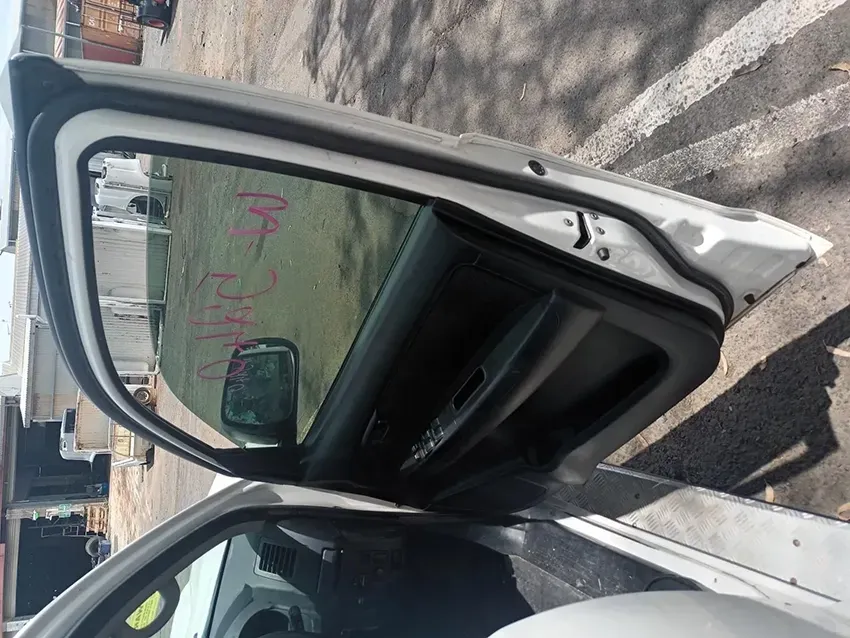 A White Car With the Door Open Has the Letters Mc Written on the Window — South West 4WD Wreckers In Brisbane, QLD