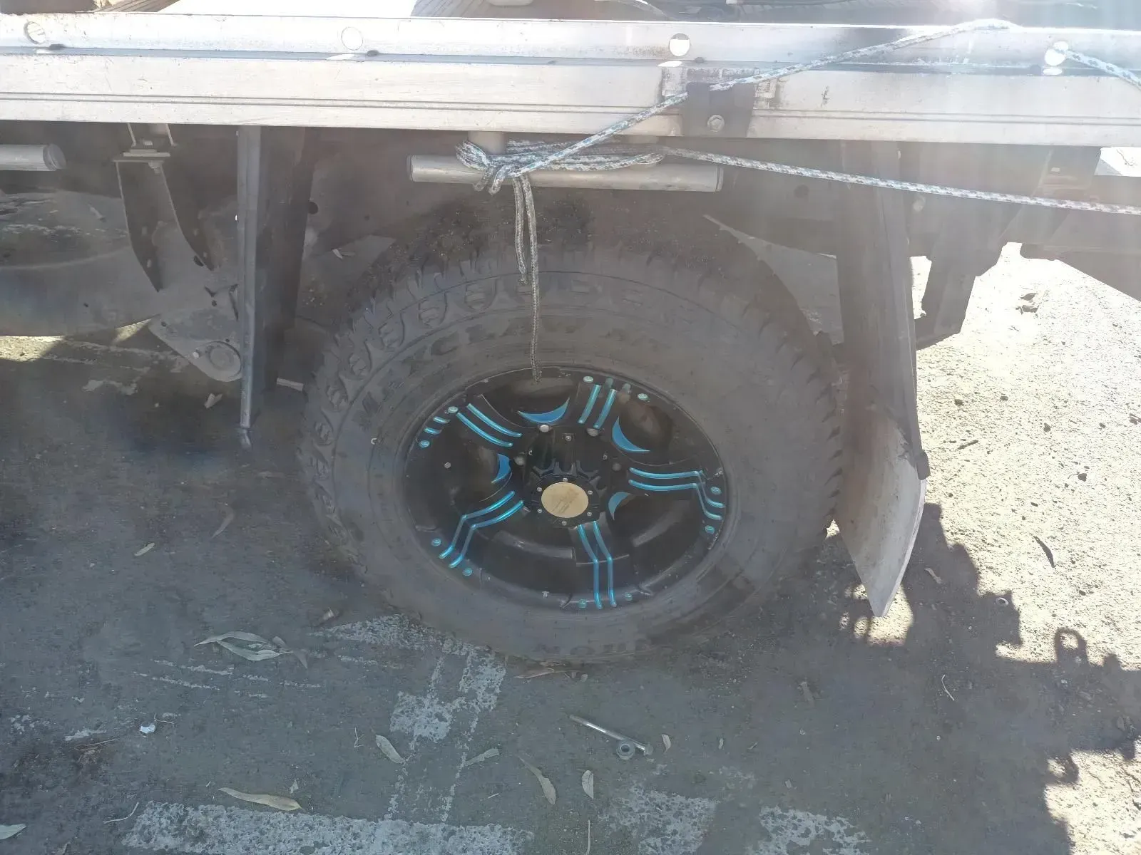 A Close-up of a Truck's Rear Tyre With Black Rim and Blue Accents — South West 4WD Wreckers In Brisbane, QLD