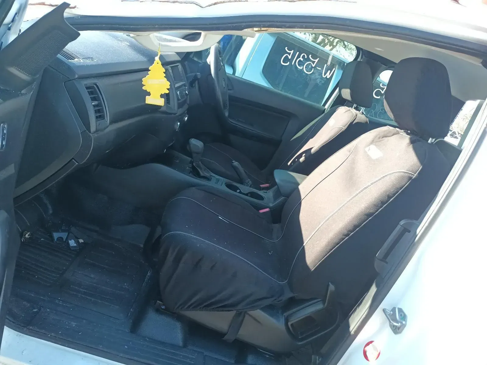 Interior of a White Pickup Truck With Black Seat Covers — South West 4WD Wreckers In Brisbane, QLD