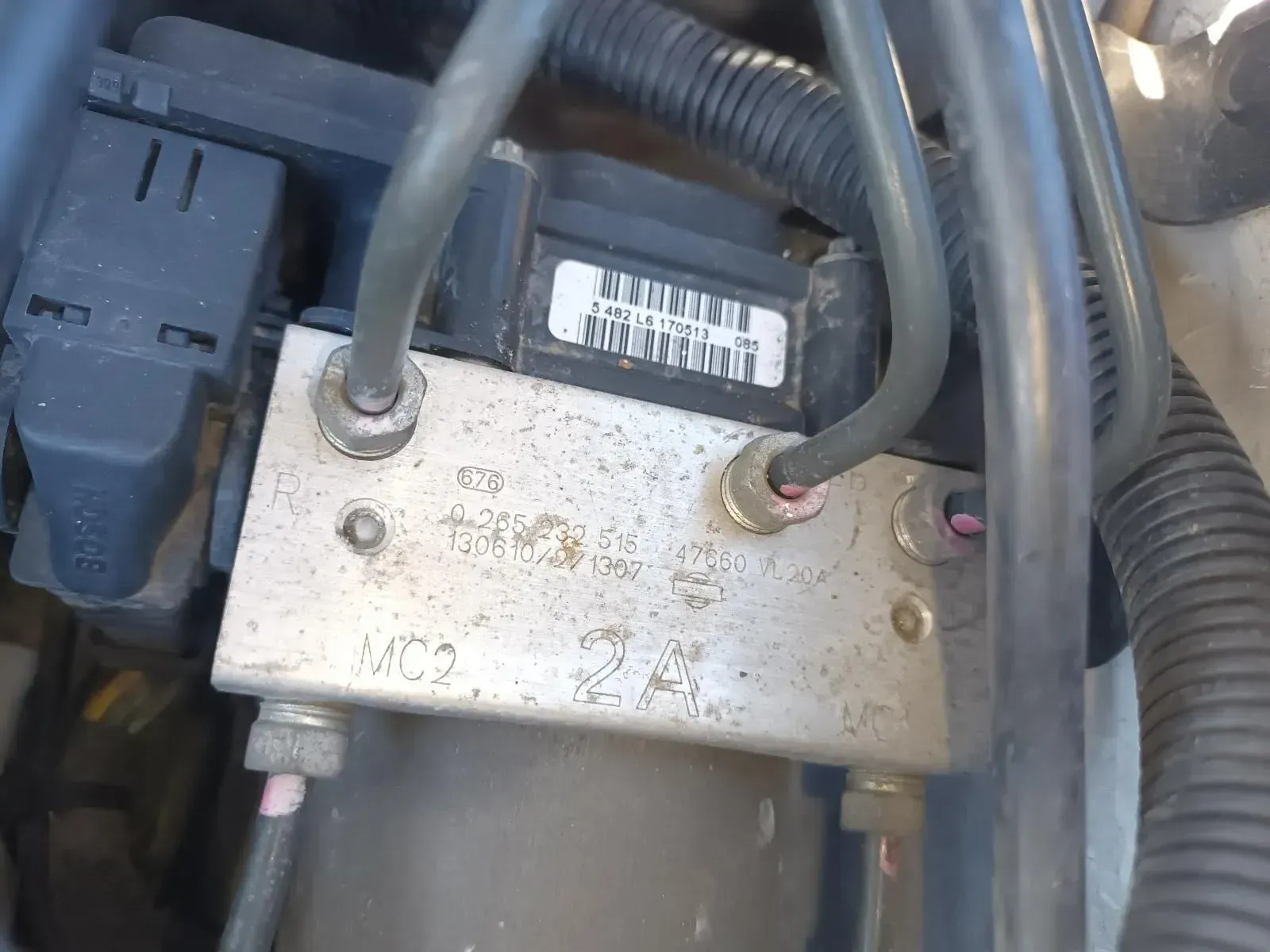 A Close-up of a Car's Abs Module With Brake Lines and Electrical Connectors — South West 4WD Wreckers In Brisbane, QLD