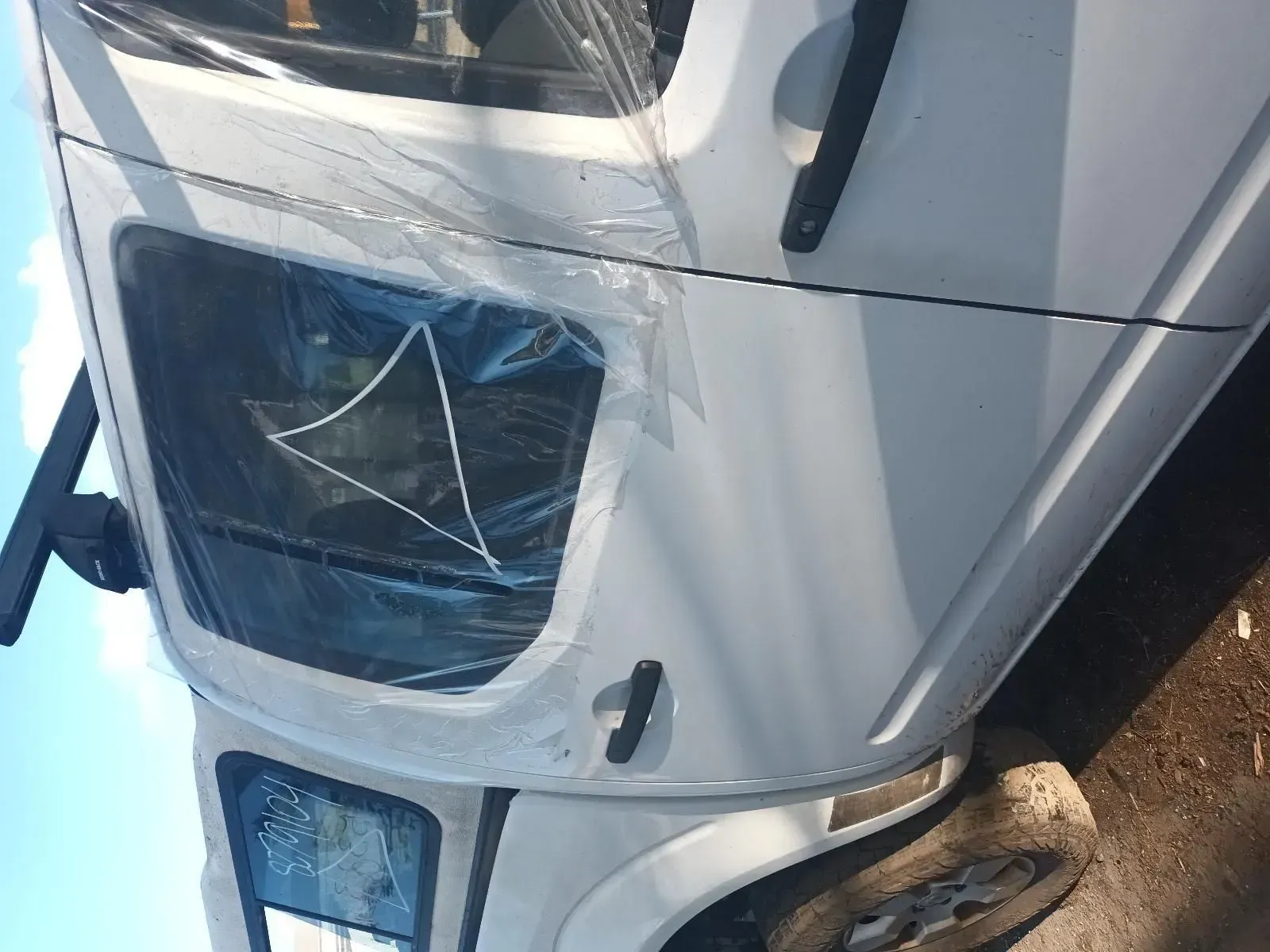 White Car With a Broken Window, Taped With Plastic — South West 4WD Wreckers In Brisbane, QLD