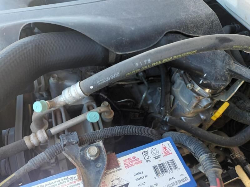 A Blue Battery is Sitting Under the Hood of a Car — South West 4WD Wreckers In Brisbane, QLD
