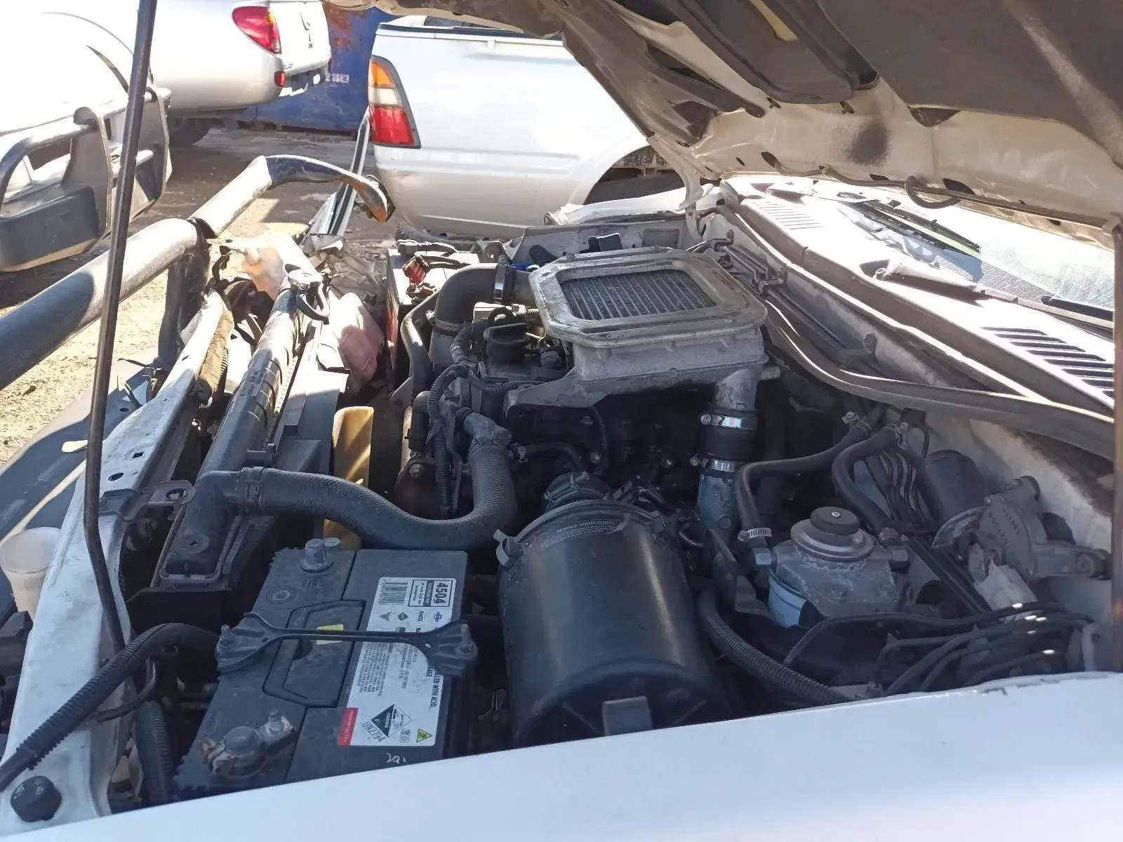 White Truck Engine With Hood Open, Showing Engine Components and Battery — South West 4WD Wreckers In Brisbane, QLD