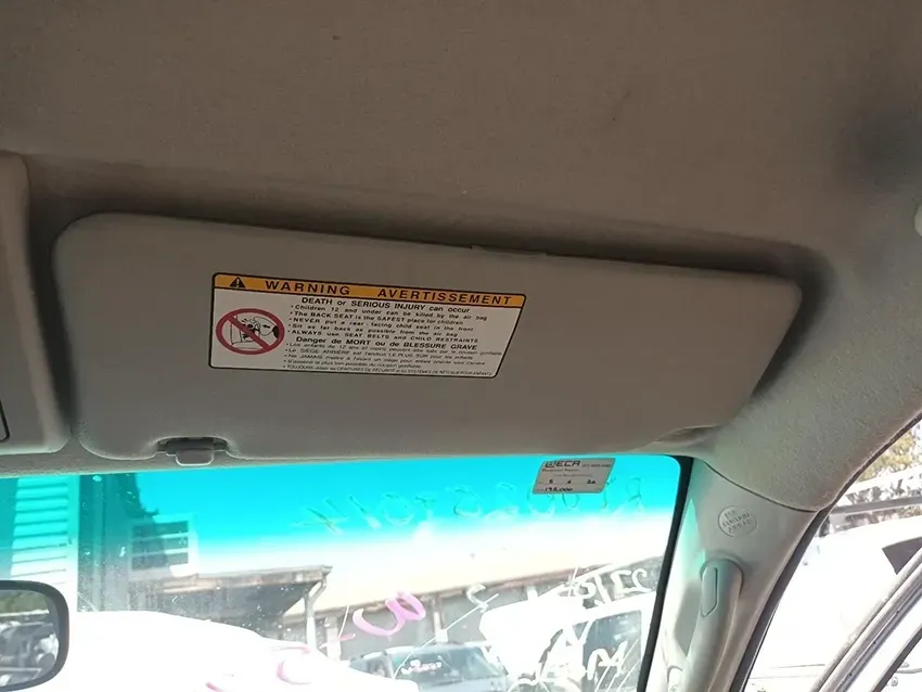 A Sun Visor in a Car With a Caution Sign on It — South West 4WD Wreckers In Brisbane, QLD