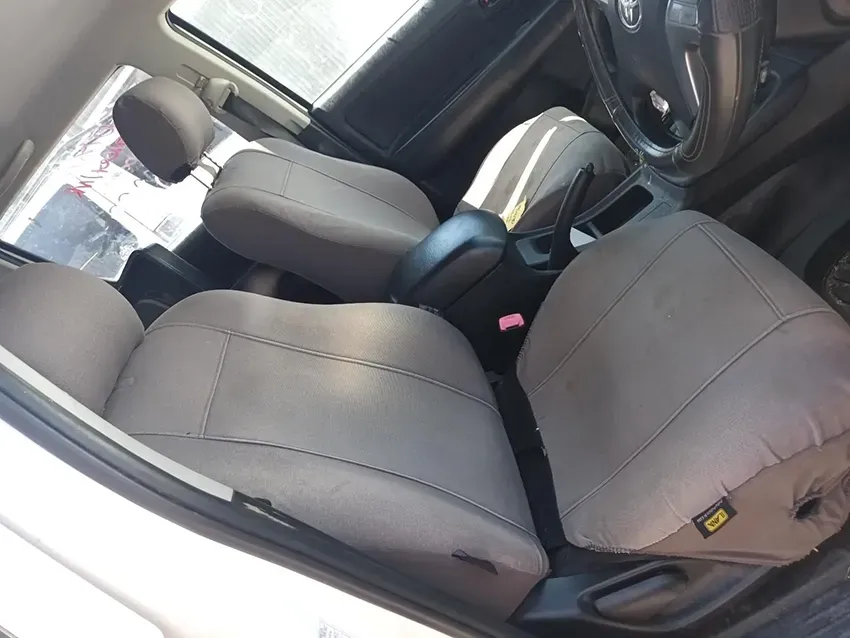 A White Car With Brown Seat Covers and a Steering Wheel — South West 4WD Wreckers In Brisbane, QLD