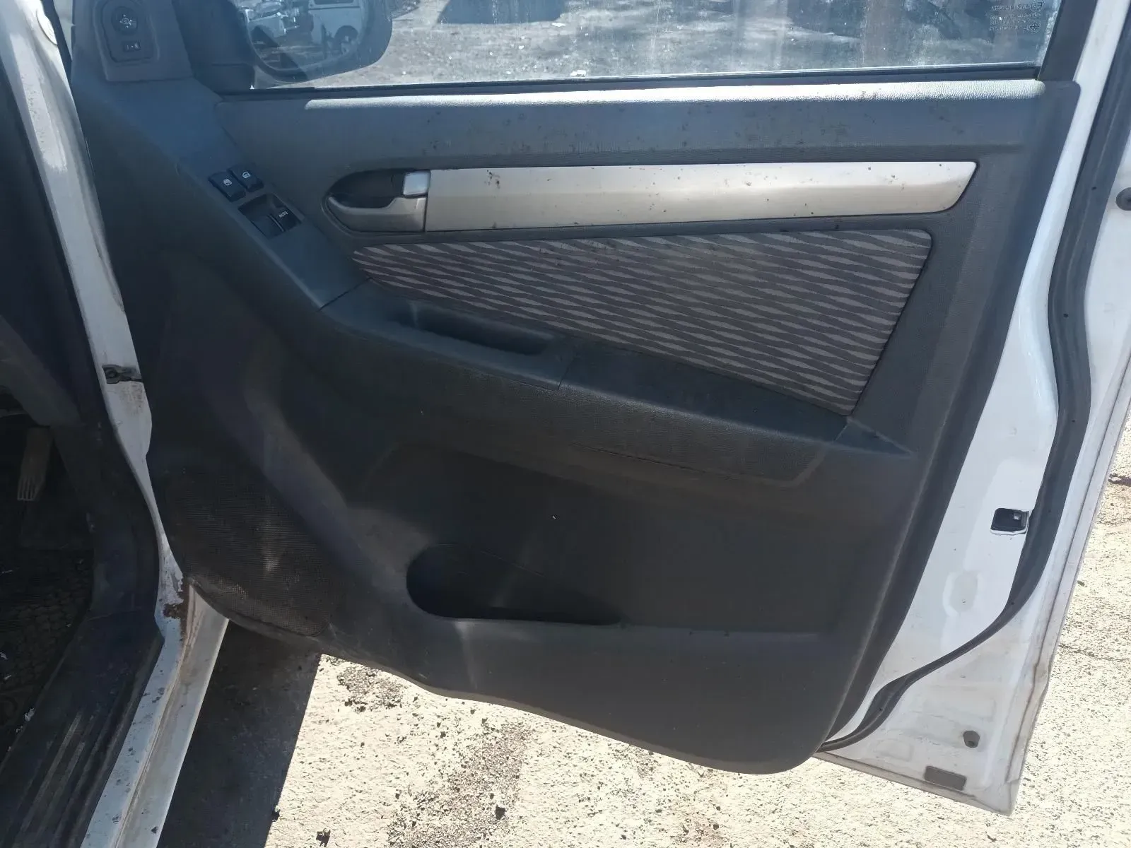 Car Door Interior, Black and Gray Paneling, Door Handle Visible, White Car Body — South West 4WD Wreckers In Brisbane, QLD