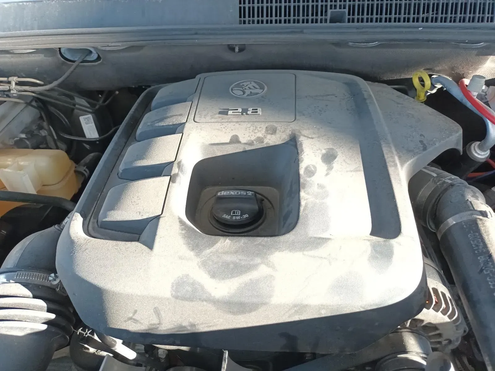A Dusty Car Engine With a Central Oil Cap and 2.8l Designation on the Engine Cover — South West 4WD Wreckers In Brisbane, QLD