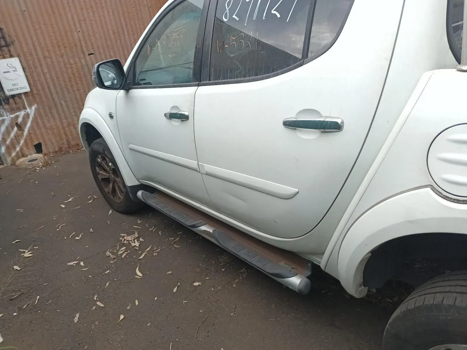 White Mitsubishi Triton Pickup Truck Parked on Asphalt — South West 4WD Wreckers In Brisbane, QLD