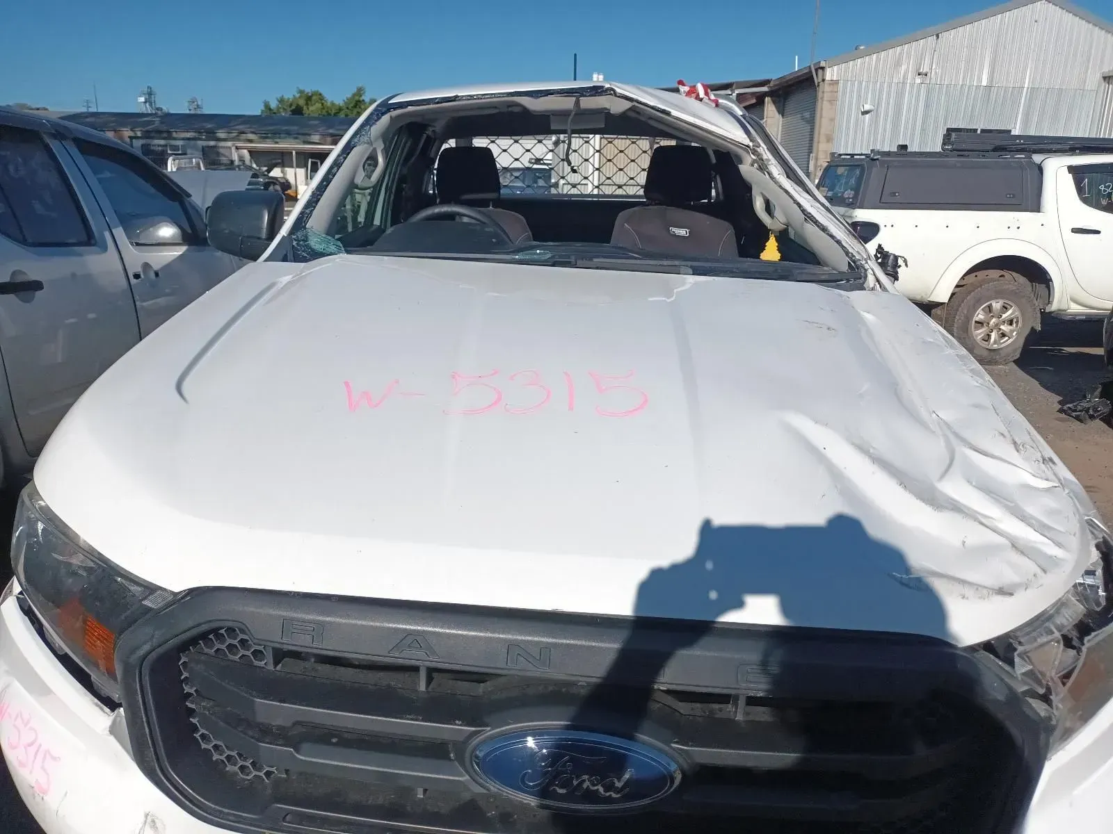 White Ford Pickup Truck, Extensively Damaged, at a Salvage Yard — South West 4WD Wreckers In Brisbane, QLD