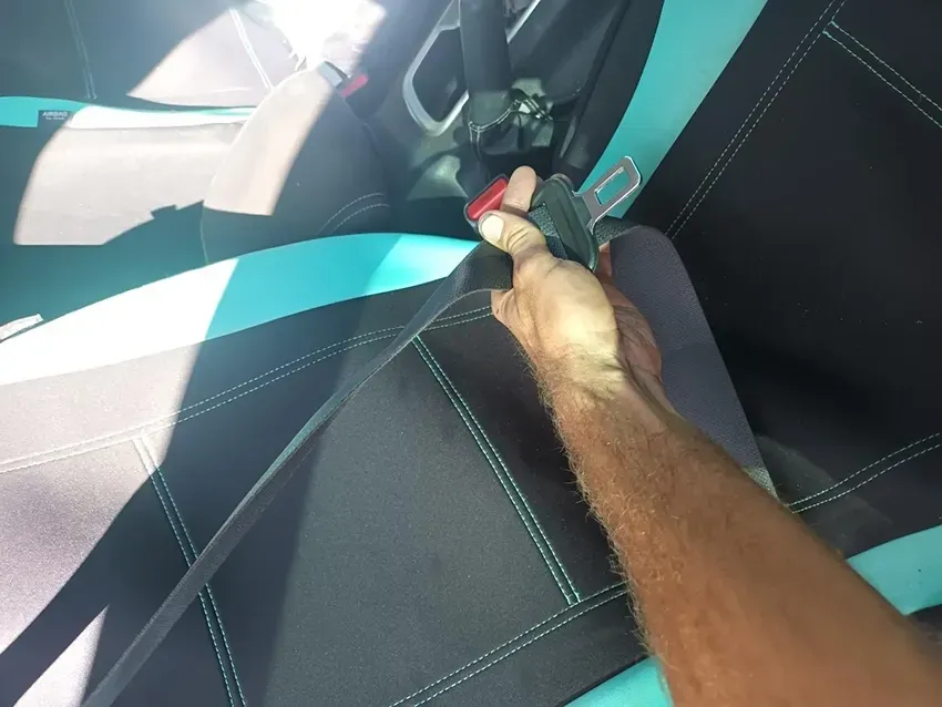 A Person is Holding a Seat Belt in a Car — South West 4WD Wreckers In Brisbane, QLD